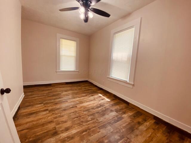 121 Maple St, London, OH 43140 - unfurnished room featuring ceiling fan and dark wood finished floors