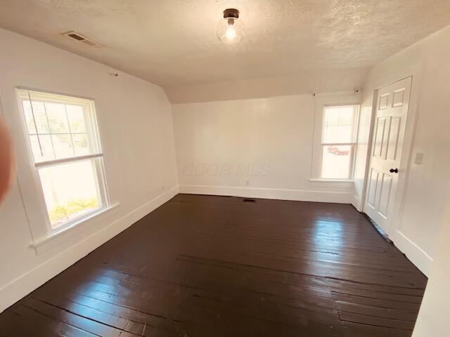 121 Maple St, London, OH 43140 - empty room with dark wood finished floors and a textured ceiling