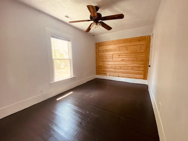 121 Maple St, London, OH 43140 - empty room featuring a ceiling fan and dark wood finished floors