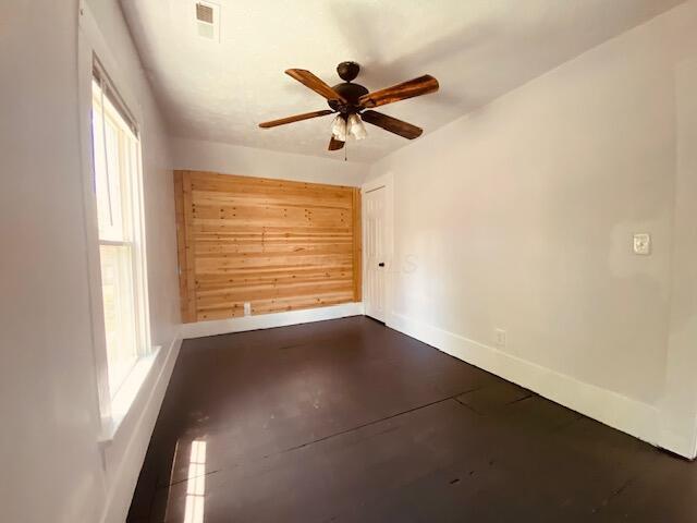 121 Maple St, London, OH 43140 - empty room featuring a ceiling fan and concrete flooring