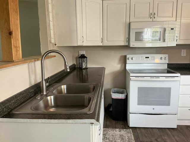 8565 Smith Calhoun Rd Unit 163, Plain City, OH 43064 - kitchen with white appliances, dark countertops, white cabinets, and dark wood finished floors