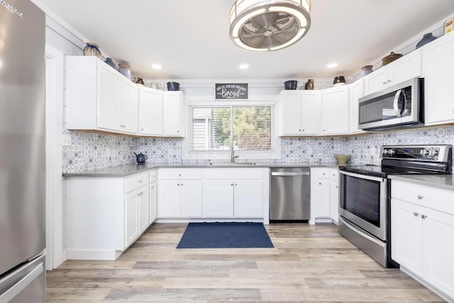 14060 Seminole Path, Lakeview, OH 43331 - kitchen with appliances with stainless steel finishes, decorative backsplash, light countertops, white cabinetry, and recessed lighting