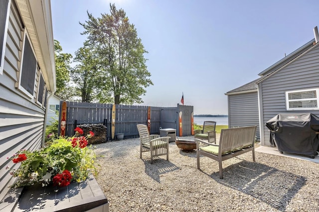 14060 Seminole Path, Lakeview, OH 43331 - view of patio featuring a grill, a fire pit, and a water view