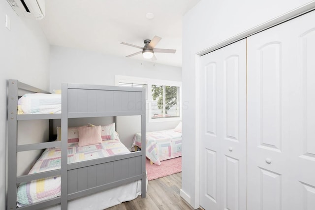14060 Seminole Path, Lakeview, OH 43331 - bedroom featuring wood finished floors, a wall mounted air conditioner, a closet, and a ceiling fan