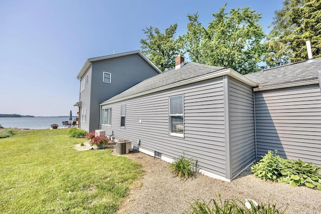 14060 Seminole Path, Lakeview, OH 43331 - view of side of home featuring a lawn, a water view, a chimney, and roof with shingles