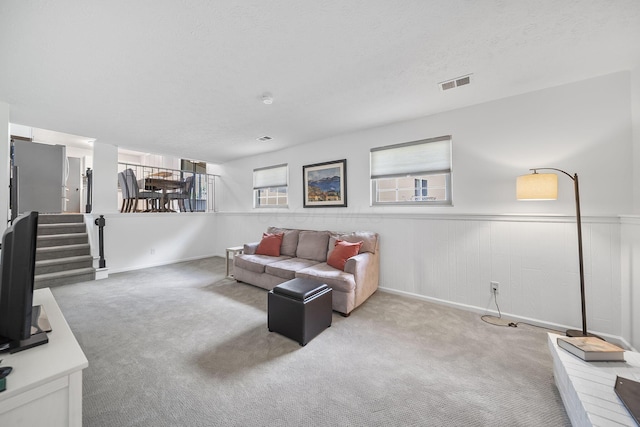 279 Old Coach Pl, Canal Winchester, OH 43110 - living room with carpet floors, wainscoting, stairs, and a textured ceiling