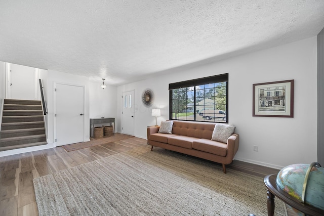 279 Old Coach Pl, Canal Winchester, OH 43110 - living area with wood finished floors, stairs, and a textured ceiling