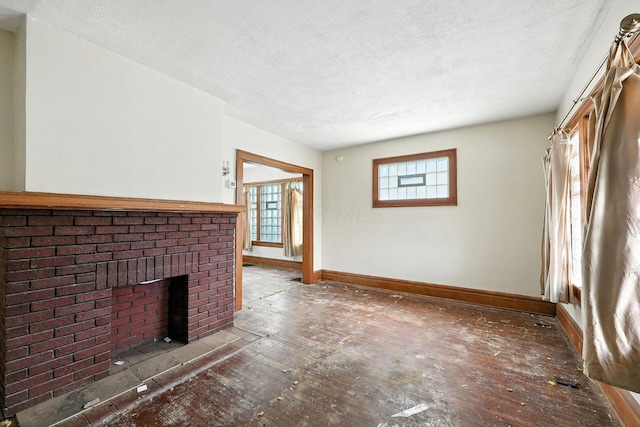 741 Heyl Ave, Columbus, OH 43206 - unfurnished living room with a textured ceiling and a brick fireplace