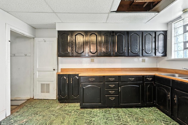 741 Heyl Ave, Columbus, OH 43206 - kitchen featuring a paneled ceiling and dark cabinetry