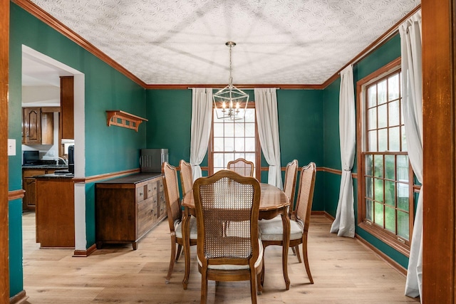 1169 Riva Ridge Blvd, Columbus, OH 43230 - dining space with ornamental molding, a chandelier, light wood-style flooring, and a textured ceiling