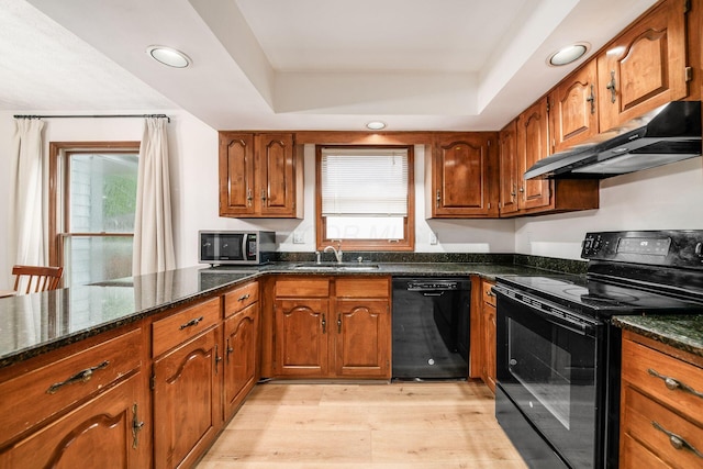 1169 Riva Ridge Blvd, Columbus, OH 43230 - kitchen with black appliances, under cabinet range hood, brown cabinets, light wood-type flooring, and recessed lighting