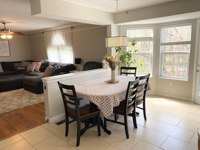 19 Ravine View Ct, Pataskala, OH 43062 - dining room featuring a textured ceiling, ceiling fan, and light tile patterned floors