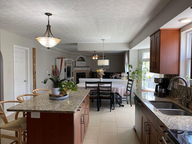 19 Ravine View Ct, Pataskala, OH 43062 - kitchen featuring ceiling fan, stainless steel dishwasher, a fireplace, light stone countertops, and open floor plan