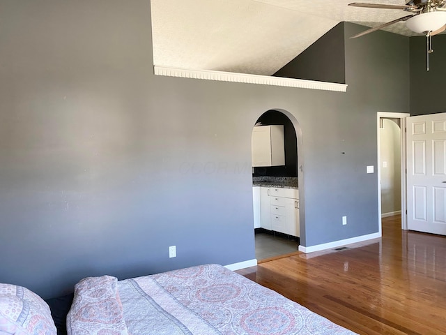 19 Ravine View Ct, Pataskala, OH 43062 - bedroom with arched walkways, dark wood-type flooring, high vaulted ceiling, and a ceiling fan