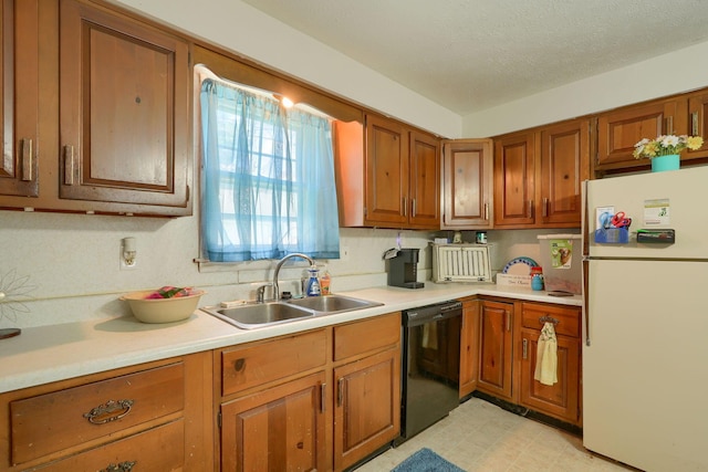 124 Wyandotte St, Lancaster, OH 43130 - kitchen with freestanding refrigerator, dishwasher, brown cabinetry, light countertops, and light flooring