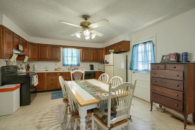 124 Wyandotte St, Lancaster, OH 43130 - kitchen featuring black appliances, light floors, a textured ceiling, ceiling fan, and under cabinet range hood