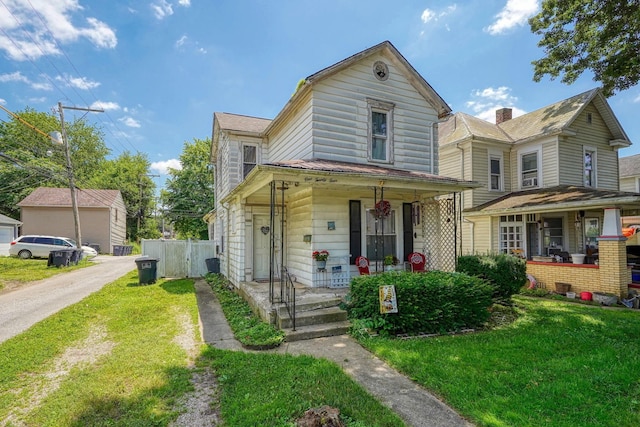 124 Wyandotte St, Lancaster, OH 43130 - traditional-style home featuring covered porch and a front lawn