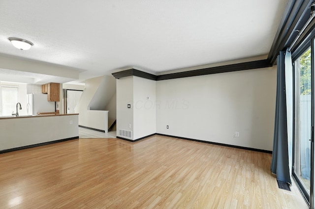 2663 Cedar Lake Dr, Dublin, OH 43016 - unfurnished living room featuring light wood-type flooring and stairway