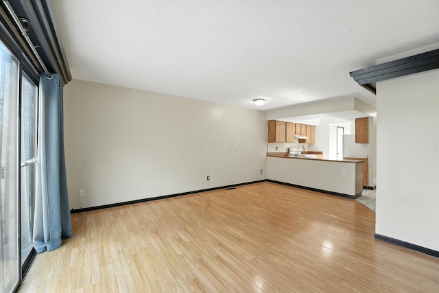 2663 Cedar Lake Dr, Dublin, OH 43016 - unfurnished living room featuring light wood finished floors and a sink