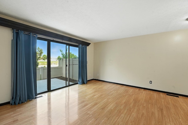 2663 Cedar Lake Dr, Dublin, OH 43016 - spare room featuring light wood-style floors and a textured ceiling