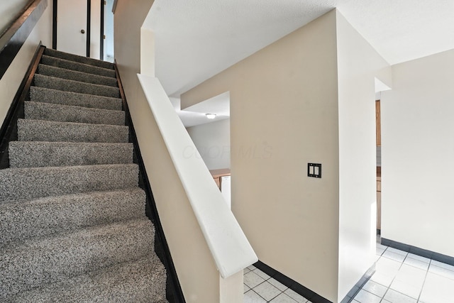 2663 Cedar Lake Dr, Dublin, OH 43016 - stairway featuring tile patterned flooring and baseboards
