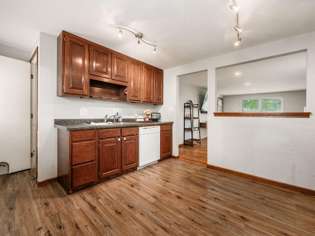 1410 Chelmsford Sq S, Columbus, OH 43229 - kitchen with dishwasher, dark countertops, wood finished floors, rail lighting, and brown cabinets