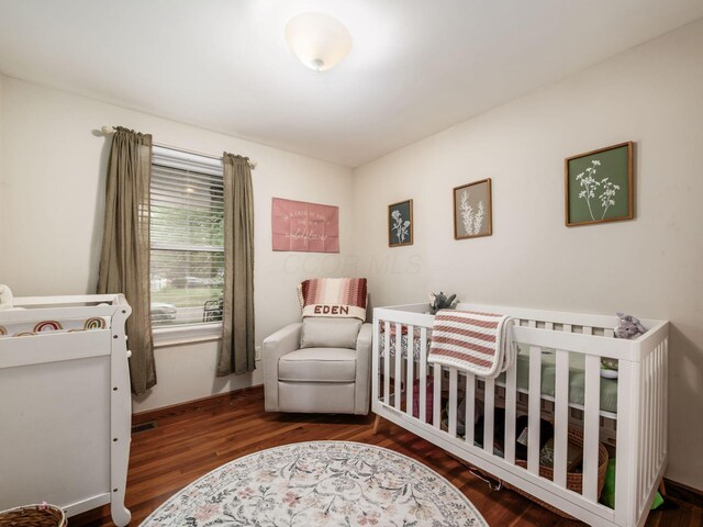 1410 Chelmsford Sq S, Columbus, OH 43229 - bedroom featuring wood finished floors and a crib