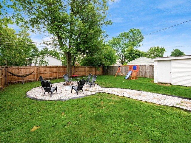 1410 Chelmsford Sq S, Columbus, OH 43229 - fenced backyard with an outdoor fire pit, a storage shed, and a playground