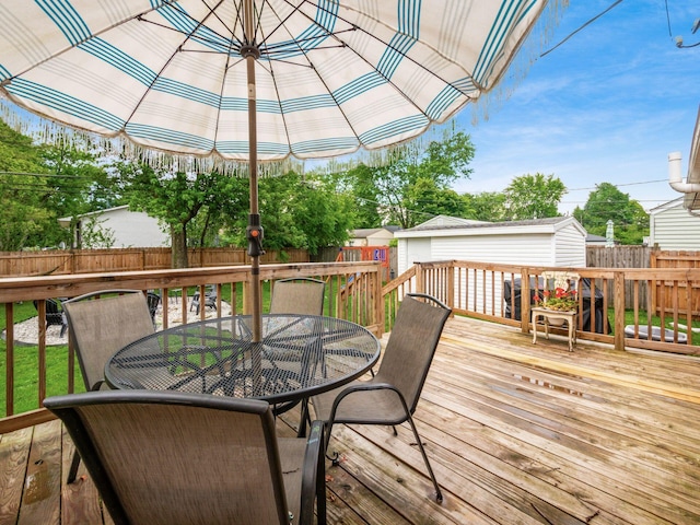 1410 Chelmsford Sq S, Columbus, OH 43229 - deck with outdoor dining space, a fenced backyard, and an outdoor structure