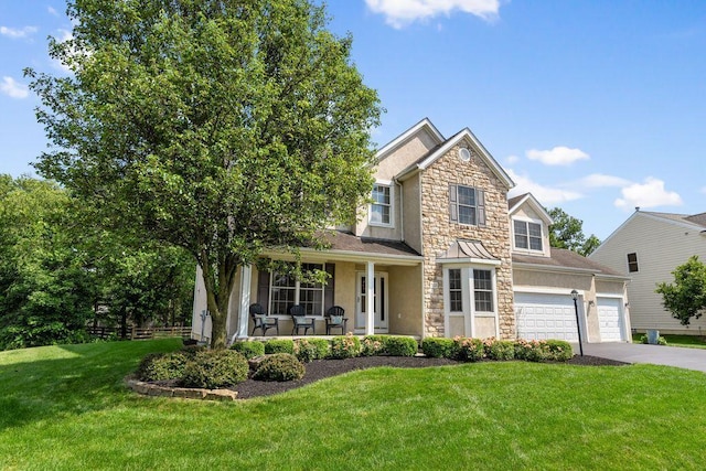 7125 Marrisey Loop, Galena, OH 43021 - view of front facade featuring stone siding, driveway, stucco siding, and a garage