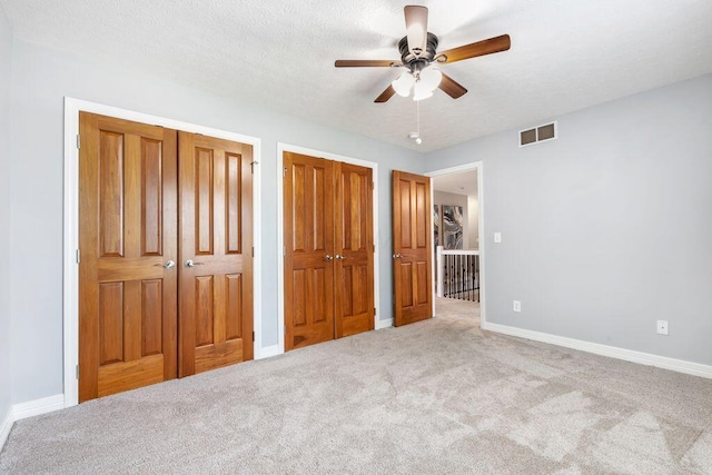 7125 Marrisey Loop, Galena, OH 43021 - unfurnished bedroom with multiple closets, carpet, and a ceiling fan