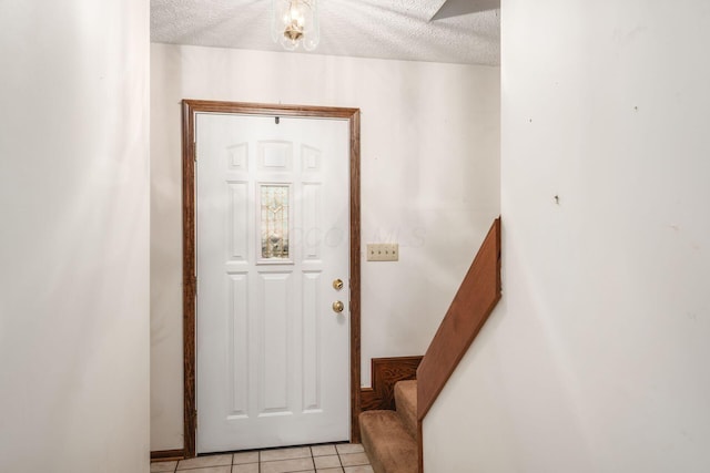 6945 Cooper Rd, Westerville, OH 43081 - entrance foyer featuring stairs, a textured ceiling, and light tile patterned flooring