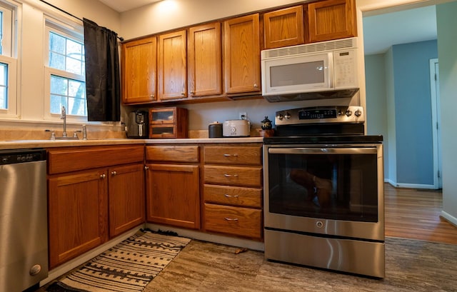 4754 Amesbury Way, Columbus, OH 43228 - kitchen with appliances with stainless steel finishes, wood finished floors, brown cabinetry, and light countertops