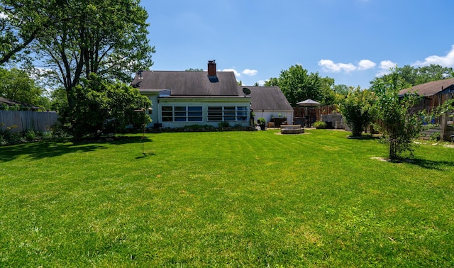 4754 Amesbury Way, Columbus, OH 43228 - rear view of property featuring a fenced backyard, a fire pit, and a chimney