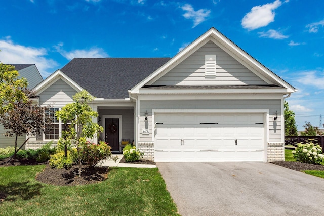 3031 Sinatra Way, Powell, OH 43065 - view of front facade with brick siding, driveway, a garage, and a shingled roof