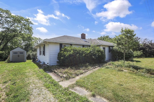 7688 State Route 257, Prospect, OH 43342 - view of side of home featuring a lawn, a shed, and a chimney
