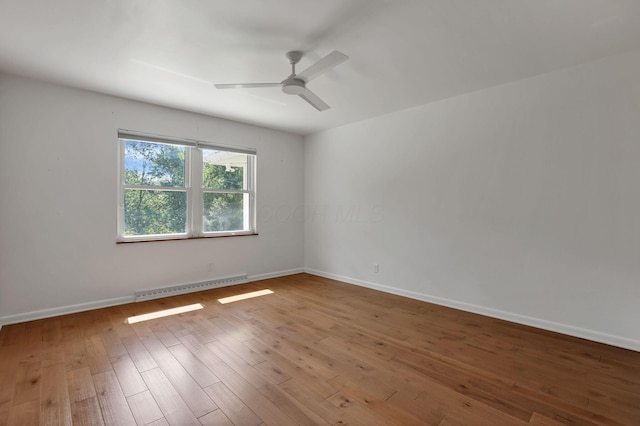 7688 State Route 257, Prospect, OH 43342 - unfurnished room with a baseboard radiator, a ceiling fan, and wood-type flooring