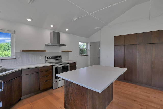 7688 State Route 257, Prospect, OH 43342 - kitchen with wall chimney exhaust hood, stainless steel range with electric cooktop, lofted ceiling, light countertops, and light wood-style flooring