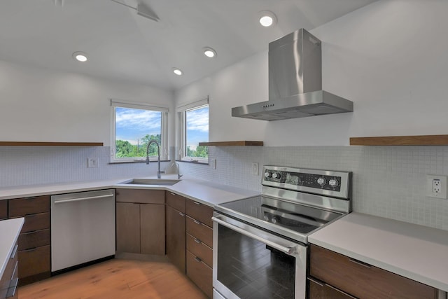 7688 State Route 257, Prospect, OH 43342 - kitchen with stainless steel appliances, wall chimney range hood, light countertops, light wood-type flooring, and decorative backsplash