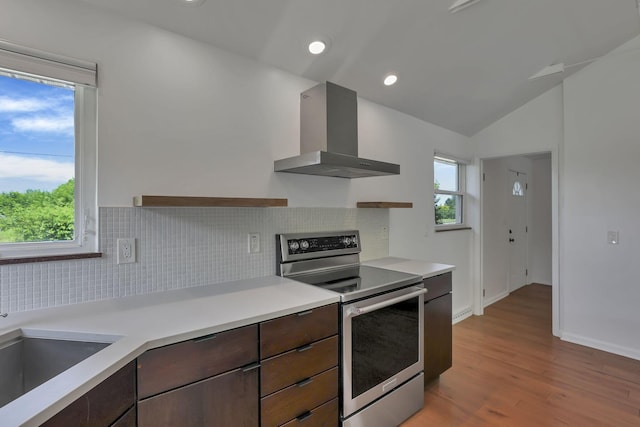 7688 State Route 257, Prospect, OH 43342 - kitchen with electric stove, wall chimney exhaust hood, decorative backsplash, light countertops, and lofted ceiling