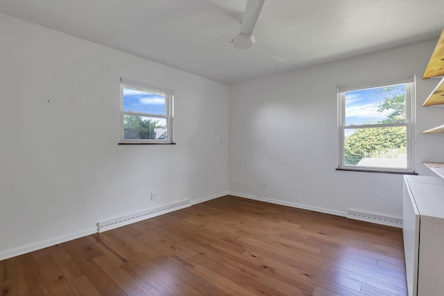 7688 State Route 257, Prospect, OH 43342 - empty room with baseboard heating, ceiling fan, wood-type flooring, and healthy amount of natural light