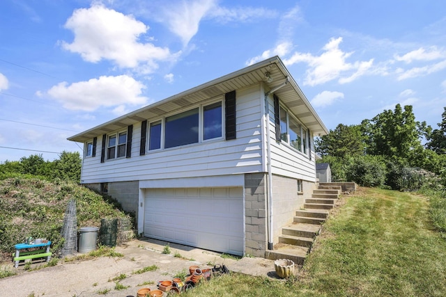 7688 State Route 257, Prospect, OH 43342 - view of side of property with a garage, stairs, and dirt driveway
