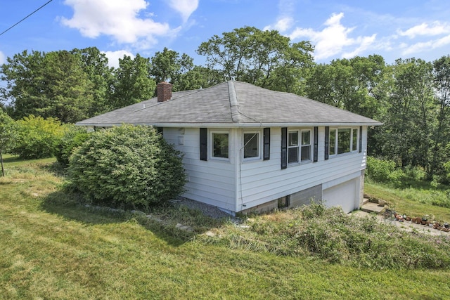 7688 State Route 257, Prospect, OH 43342 - view of side of home featuring a chimney, a lawn, an attached garage, and a shingled roof