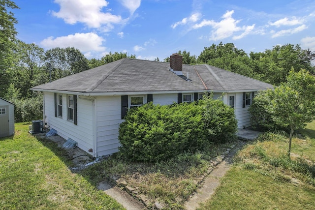 7688 State Route 257, Prospect, OH 43342 - view of front of home featuring a chimney, a front lawn, and an outbuilding