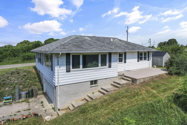 7688 State Route 257, Prospect, OH 43342 - back of property with a shingled roof, a storage shed, and a yard