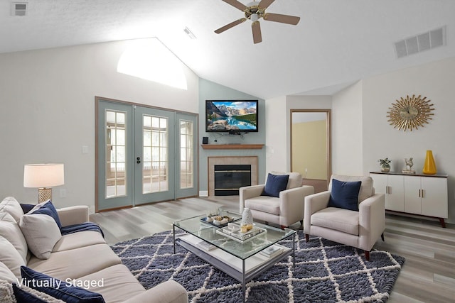 3712 E Links Cir, Hilliard, OH 43026 - living area with light wood-style floors, ceiling fan, high vaulted ceiling, a fireplace, and french doors