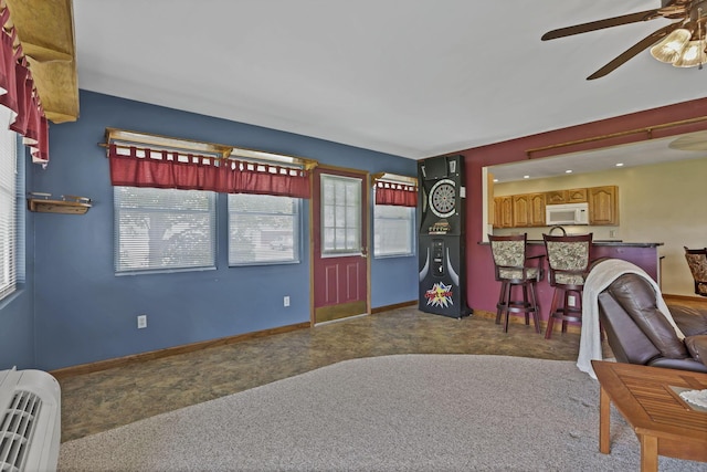 201 Christopher Ct, Hebron, OH 43025 - carpeted living room with a ceiling fan and a bar