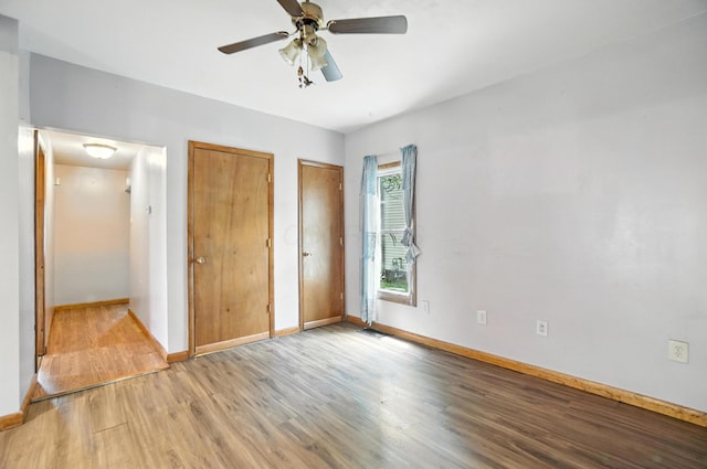 99 N Williams St, Newark, OH 43055 - unfurnished bedroom with multiple closets, light wood finished floors, and a ceiling fan