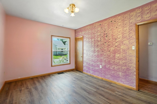 99 N Williams St, Newark, OH 43055 - spare room with wood finished floors and a chandelier