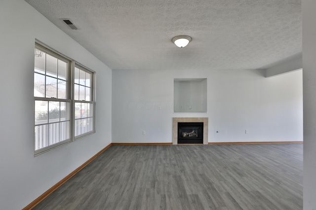 1852 Meadowlawn Dr, Columbus, OH 43219 - unfurnished living room featuring wood finished floors, a fireplace, and a textured ceiling